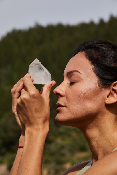 Young Woman Holding a Crystal Outdoors