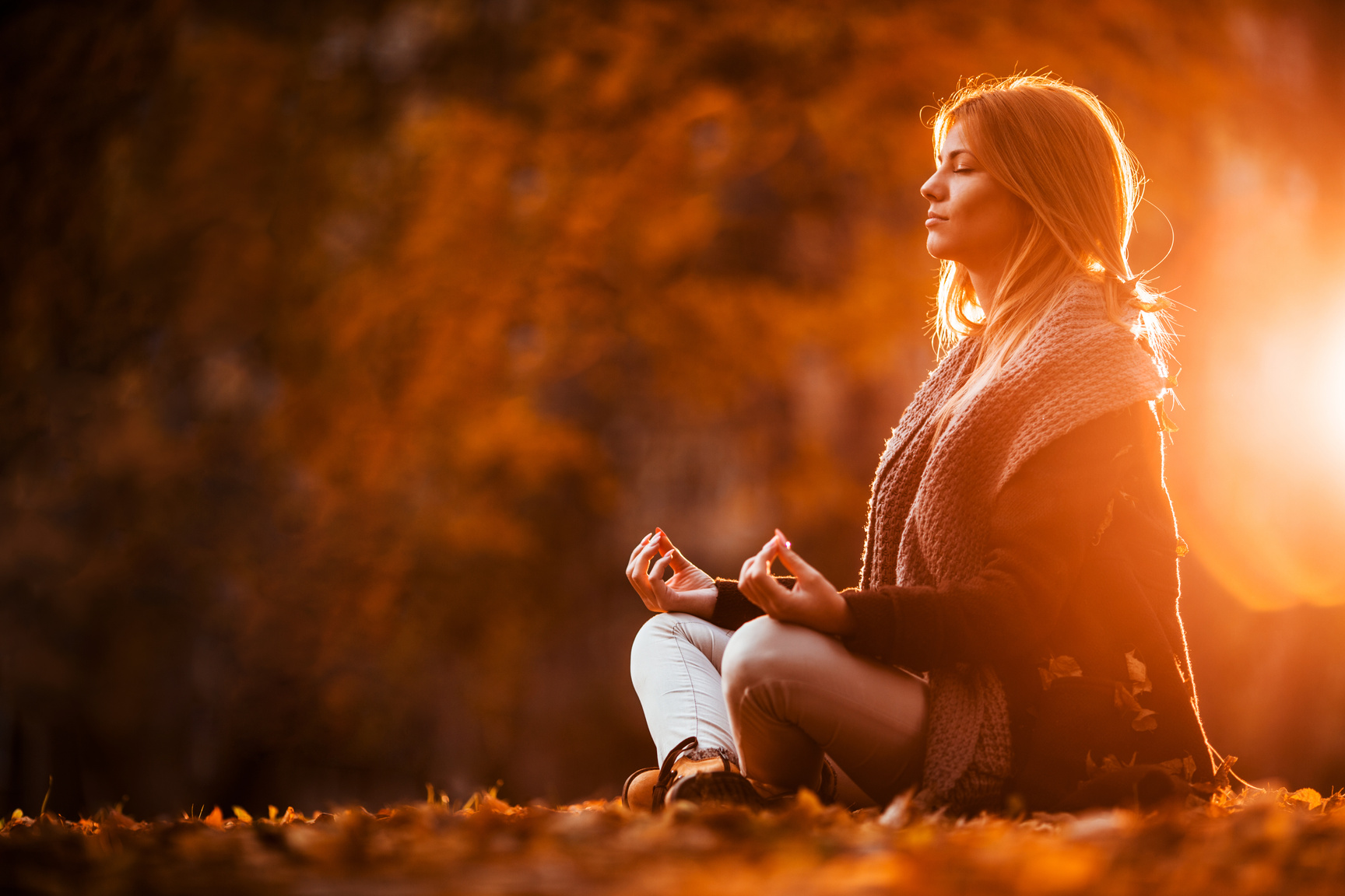 Woman meditating in autumn day.