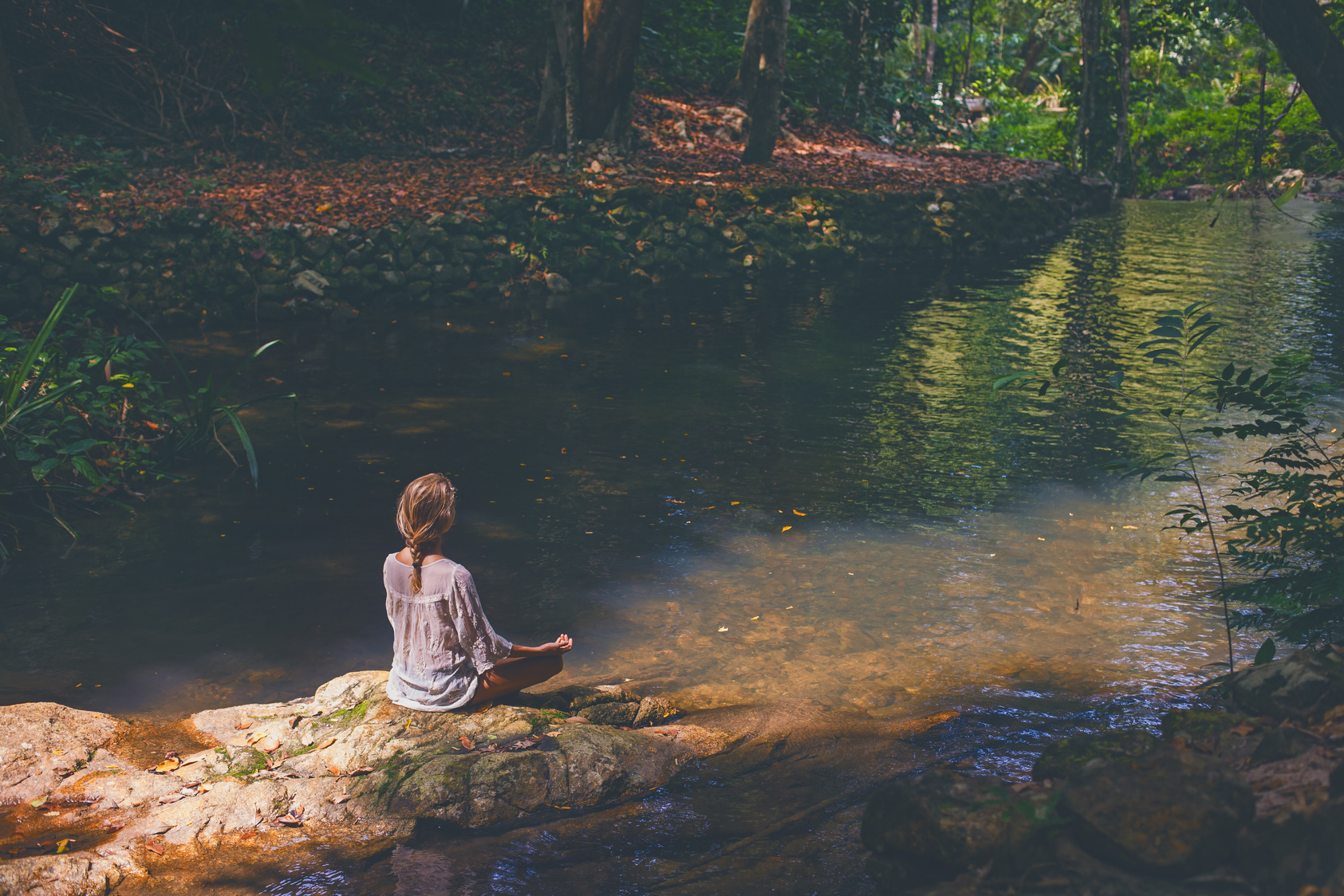 Woman mediting  in tropical forest