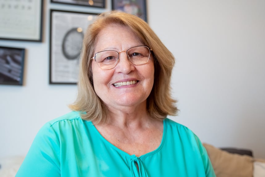 A Woman in Teal Scoop Neck Shirt Wearing Eyeglasses